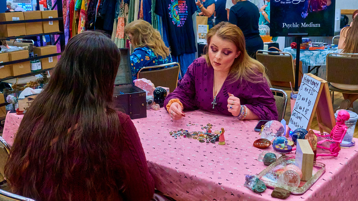 One-to-one consultation across a colorful table at the Grapevine Wellness Expo, October 10–11, 2026.