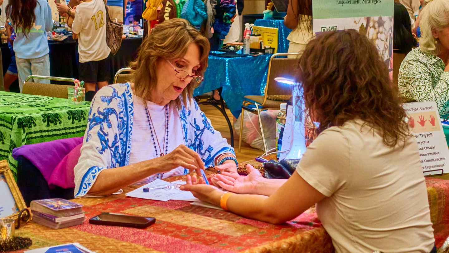 Hands-on conversation at a service table at the Grapevine Wellness Expo, October 10–11, 2026.