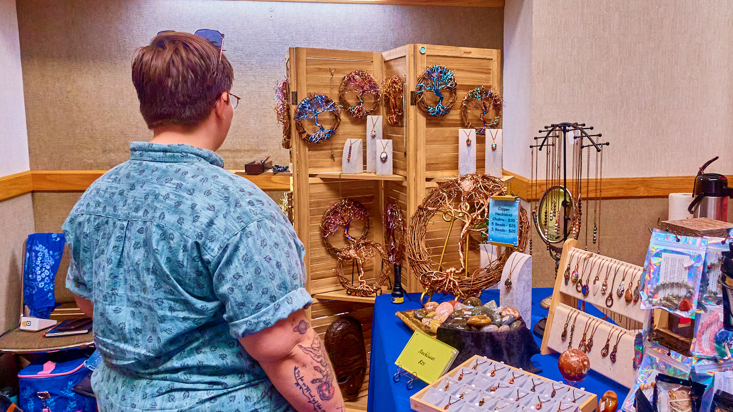 Visitor browsing handcrafted displays at the Grapevine Wellness Expo, October 10–11, 2026.