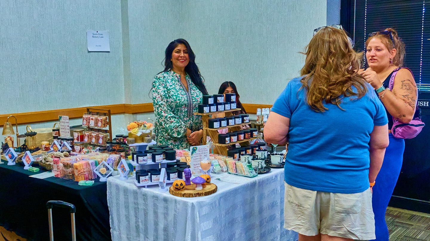 Visitors connecting around a vendor table at the Grapevine Wellness Expo, October 10–11, 2026.