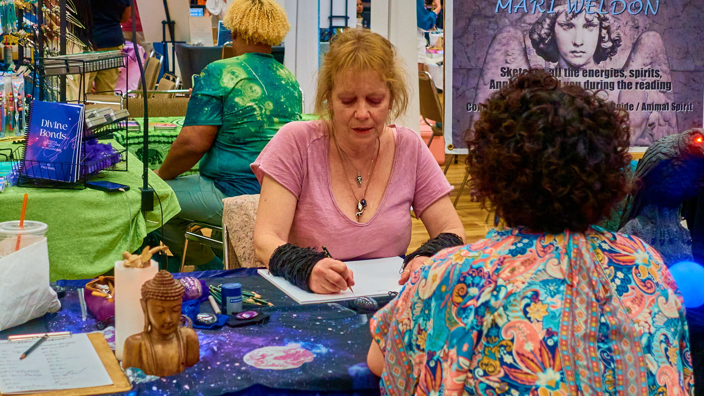 Small-group conversation across the table at the Grapevine Wellness Expo, October 10–11, 2026.